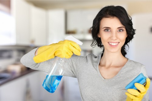 Cleaning professional using PPE during a detailed safety-focused task