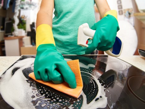 Local cleaner working in a Westhampstead kitchen and living area